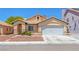 Inviting single-story house featuring a two-car garage and low-maintenance desert landscaping at 4619 Reliant St, North Las Vegas, NV 89031