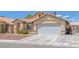 Cozy single-story home with a two-car garage, desert landscaping, and charming curb appeal at 4619 Reliant St, North Las Vegas, NV 89031