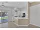 Stylish kitchen with white cabinets, a breakfast bar, and sliding door access to a manicured backyard at 4619 Reliant St, North Las Vegas, NV 89031