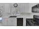 Updated kitchen featuring white cabinets, modern appliances, and views of the landscaped backyard at 4619 Reliant St, North Las Vegas, NV 89031