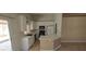 Bright kitchen featuring white cabinets, breakfast bar, and backyard access at 4619 Reliant St, North Las Vegas, NV 89031