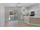Bright kitchen featuring white cabinets, tile floors, and sliding glass doors leading to the backyard at 4619 Reliant St, North Las Vegas, NV 89031