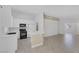Bright kitchen with white cabinetry, modern appliances, and a breakfast bar that opens to the living area at 4619 Reliant St, North Las Vegas, NV 89031
