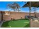 Backyard with a putting green, and comfortable outdoor seating, perfect for relaxation at 4977 Birchland Manor Ave, Las Vegas, NV 89139