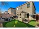 Well-maintained backyard with artificial turf, and a lovely outdoor seating area at 4977 Birchland Manor Ave, Las Vegas, NV 89139