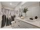 Bright bathroom featuring a double sink vanity with white countertops and modern fixtures at 4977 Birchland Manor Ave, Las Vegas, NV 89139