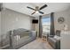 This well-appointed Bedroom features a crib, a comfortable chair, and a decorative ceiling fan at 4977 Birchland Manor Ave, Las Vegas, NV 89139