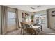 Dining room area showcases modern light fixture and sliding door to the outside patio at 4977 Birchland Manor Ave, Las Vegas, NV 89139