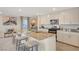 Modern kitchen with a large island, granite countertops, stylish seating, and stainless steel appliances at 4977 Birchland Manor Ave, Las Vegas, NV 89139