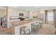 Contemporary kitchen featuring a spacious island, sleek cabinetry, and modern appliances, adjacent to dining at 4977 Birchland Manor Ave, Las Vegas, NV 89139