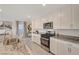 Bright kitchen boasts granite counters, stainless appliances, and island sink at 4977 Birchland Manor Ave, Las Vegas, NV 89139