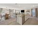 Open floorplan living area with island seating, dining area, and comfortable furnishings at 4977 Birchland Manor Ave, Las Vegas, NV 89139