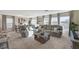Open living room featuring comfortable seating, large windows, and natural light, perfect for entertaining at 4977 Birchland Manor Ave, Las Vegas, NV 89139