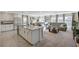 Open-concept living space with a modern kitchen island and living area with natural light at 4977 Birchland Manor Ave, Las Vegas, NV 89139