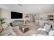 Cozy living room with a spacious layout, neutral tones, and a seamless connection to the kitchen area at 4977 Birchland Manor Ave, Las Vegas, NV 89139