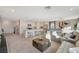 Bright and airy living space showcasing modern decor, plush seating, and seamless flow to the kitchen at 4977 Birchland Manor Ave, Las Vegas, NV 89139