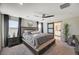 Spacious main bedroom with a decorative ceiling fan, and an ensuite bathroom at 4977 Birchland Manor Ave, Las Vegas, NV 89139