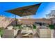 Inviting patio featuring comfortable seating arrangements and a stylish umbrella at 4977 Birchland Manor Ave, Las Vegas, NV 89139