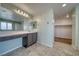 Bright bathroom featuring a spacious vanity, tile flooring, and walk in closet leading to additional storage and functionality at 5460 Chippewa, Pahrump, NV 89061