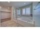 Bright bathroom features a tub, tile flooring, walk-in shower, and ample space, combining comfort and functionality at 5460 Chippewa, Pahrump, NV 89061