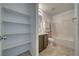 Bright bathroom with a vanity, toilet, shower with tub, and a built in shelving unit at 5460 Chippewa, Pahrump, NV 89061