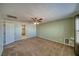 A cozy carpeted bedroom features neutral walls, a ceiling fan, and an adjoining walk-in closet, providing ample storage at 5460 Chippewa, Pahrump, NV 89061