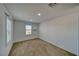 A bright bedroom with neutral carpet, a window with plantation shutters and overhead lighting at 5460 Chippewa, Pahrump, NV 89061