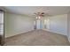 An airy bedroom showcases plush carpeting, neutral-colored walls, and convenient access to both a closet and the en-suite bathroom at 5460 Chippewa, Pahrump, NV 89061