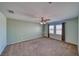Spacious carpeted bedroom with ceiling fan, light green walls, and bright natural light creates a calm and relaxing atmosphere at 5460 Chippewa, Pahrump, NV 89061