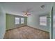 Comfortable bedroom with a ceiling fan, windows, and neutral-colored walls and carpet at 5460 Chippewa, Pahrump, NV 89061