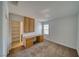 A well-lit bedroom with a built in desk and cabinets, neutral carpet, and a closet to the left of the room at 5460 Chippewa, Pahrump, NV 89061