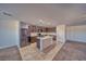 Modern kitchen featuring stainless steel appliances, a kitchen island, tile flooring and wood cabinets at 5460 Chippewa, Pahrump, NV 89061