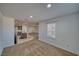 An open living area shows the kitchen with an island, carpet flooring, and lots of natural light coming through the window at 5460 Chippewa, Pahrump, NV 89061