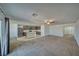 A spacious living room and kitchen with a ceiling fan, neutral paint, and updated stainless steel appliances at 5460 Chippewa, Pahrump, NV 89061