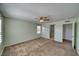 Spacious bedroom with carpet, a ceiling fan, and access to an ensuite bathroom at 5460 Chippewa, Pahrump, NV 89061