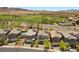 Aerial view of homes showcasing solar panels, swimming pool, and proximity to a golf course at 55 Strada Fontana, Henderson, NV 89011