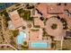 Birds eye view of the community clubhouse, pools, palm trees, and parking at 55 Strada Fontana, Henderson, NV 89011
