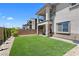 Manicured backyard with artificial grass, perfect for outdoor entertaining and relaxation at 55 Strada Fontana, Henderson, NV 89011