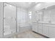 Luxurious bathroom boasts a glass-enclosed shower, soaking tub, and double vanity with stylish fixtures at 55 Strada Fontana, Henderson, NV 89011