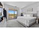 Spacious main bedroom with a private balcony and scenic views is bathed in natural light at 55 Strada Fontana, Henderson, NV 89011