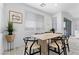 Charming dining space with wood-style tile flooring and a large window offers a bright and inviting atmosphere at 55 Strada Fontana, Henderson, NV 89011