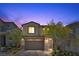 Charming two-story home with a two-car garage and well-maintained landscaping at twilight at 55 Strada Fontana, Henderson, NV 89011