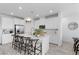 Bright kitchen features white cabinets, stainless steel appliances, and a large island with bar seating at 55 Strada Fontana, Henderson, NV 89011