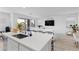 Open-concept kitchen showcases sleek countertops, stainless steel sink, and seamless flow into the living area at 55 Strada Fontana, Henderson, NV 89011
