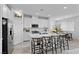 Modern kitchen with white cabinetry, an island with seating, and stainless steel appliances offers style and function at 55 Strada Fontana, Henderson, NV 89011