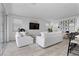 Cozy living room with white sofas, light wood floors, and lots of natural light at 55 Strada Fontana, Henderson, NV 89011