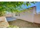 The backyard is landscaped with rock, trees, and a small patio area at 5622 Sage Pines Dr, Las Vegas, NV 89118