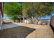 The backyard features trees, rock landscaping, and a patio area at 5622 Sage Pines Dr, Las Vegas, NV 89118
