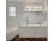 Bright bathroom featuring a double sink vanity, a shower, and a bathtub at 5622 Sage Pines Dr, Las Vegas, NV 89118