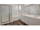 Bright bathroom featuring a double sink vanity, a shower, and a bathtub at 5622 Sage Pines Dr, Las Vegas, NV 89118
